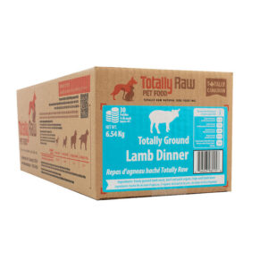 A cardboard box of Totally Raw Ground Lamb Patty 15lbs for dogs, featuring product details and nutrition information on the blue and white label.