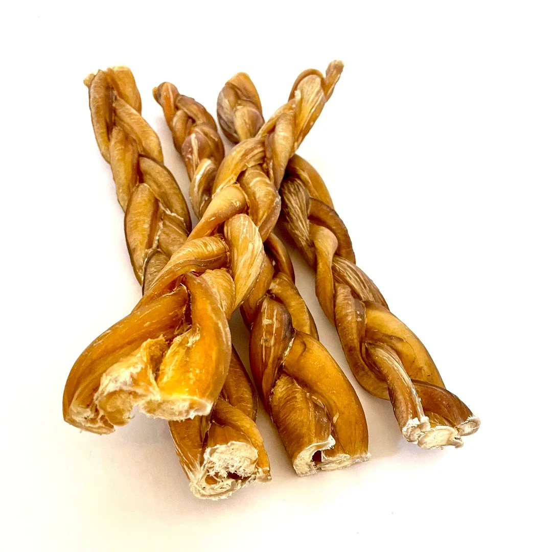 Four twisted, braided brown dog chews are arranged on a white background. The chews have a shiny, slightly rough texture and vary slightly in size and thickness.