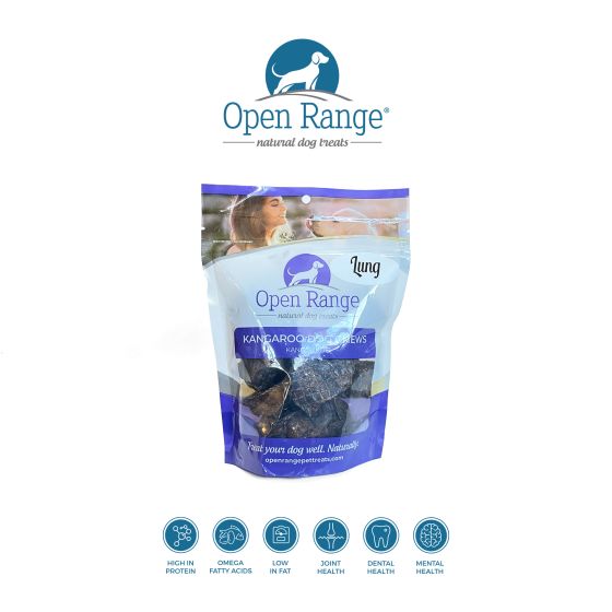 A bag of Open Range Kangaroo Lung dog treats stands upright. The packaging is purple and white with a dog image. Icons below highlight benefits like high protein, omega fatty acids, low fat, joint, dental, and mental health.