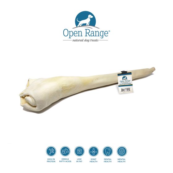 A long, natural dog chew bone with a label, displayed under the Open Range logo. Icons below highlight benefits: high protein, omega fatty acids, low in fat, joint and dental health, and mental health.
