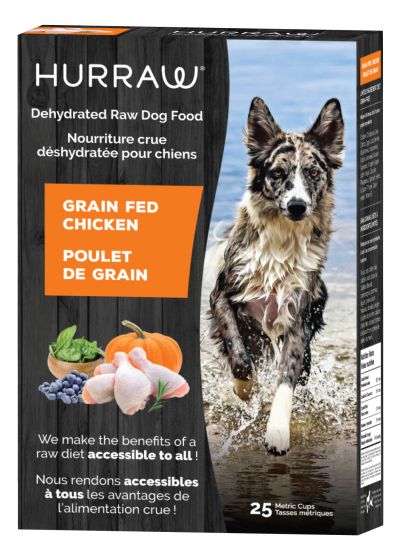 A box of Hurraw dehydrated raw dog food featuring an image of a wet dog running on a beach. The food is grain-fed chicken flavor, with illustrations of chicken, pumpkin, and blueberries. Text in English and French.