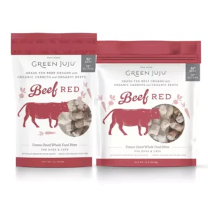 Two packages of Green Juju Beef Red freeze-dried whole food bites for dogs and cats. The bags are white with red accents and feature an illustration of a cow. The text highlights grass-fed beef organs, organic carrots, and organic beets.