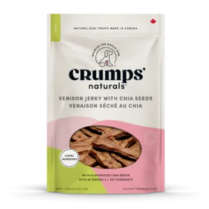 A package of Crumps' Naturals dog treats in venison jerky flavor with chia seeds. The package is off-white with a pink lower section, featuring a circular window displaying the jerky inside. It highlights limited ingredients and omega-3.