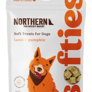 A package of Northern Dog Biscuit Bakery treats labeled "Soft Treats for Dogs" with lamb and pumpkin flavor. The package is white with orange text and features an illustration of a happy dog. The net weight is 170 grams and it's made in Canada.