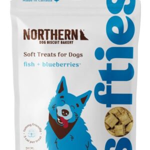 Bag of Northern Dog Biscuit Bakery soft treats for dogs, featuring fish and blueberries flavor. The packaging includes an illustration of a blue dog and a Canadian flag symbol.