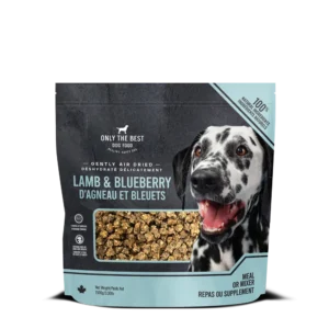 A bag of Only The Best Dog Food, Lamb & Blueberry flavor, featuring a happy Dalmatian and a see-through window showing the food inside. The packaging is blue and black with text in English and French.