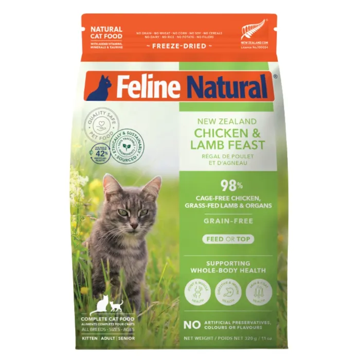 A bag of Feline Natural freeze-dried chicken and lamb feast cat food featuring a grey tabby cat in grass.