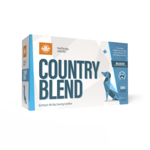 A box of Big Country Raw Country Blend 4x1lb features a blue geometric dog on a white background and is labeled as a natural food mixer for pets, net weight 4lb/1.81kg.