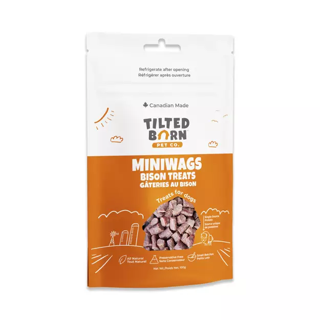 A white and orange pouch of Tilted Barn Pet Co. Miniwags Bison Treats for dogs, featuring images of bison treats, playful icons, and text highlighting it as Canadian made and all natural.
