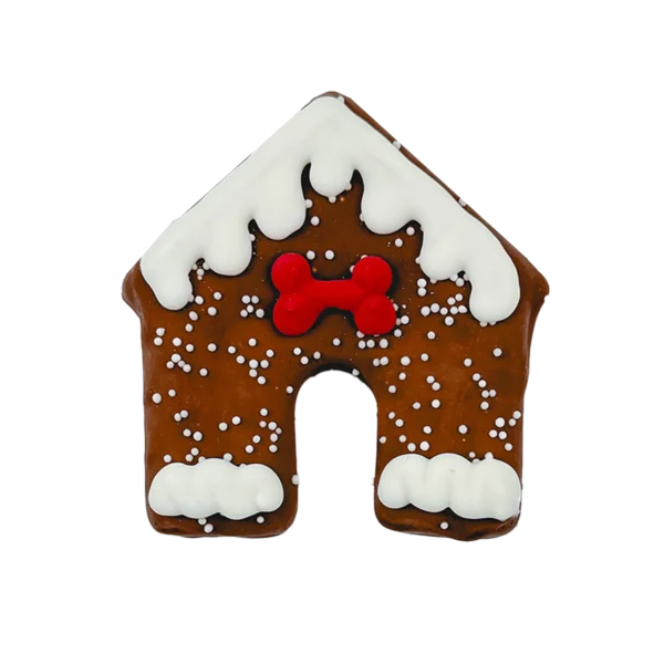 Gingerbread doghouse cookie decorated with white icing resembling snow and a red bone-shaped decoration above the door.