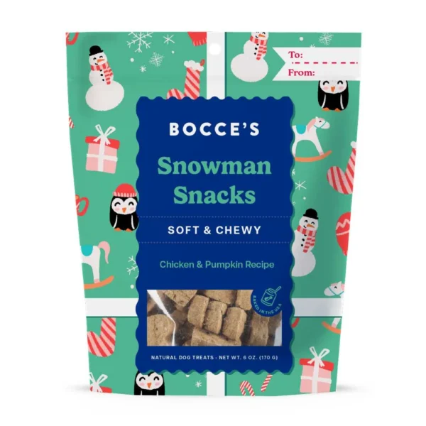 A festive package of Bocce's Snowman Snacks for dogs, featuring a colorful design with snowmen and presents. The label indicates they're soft and chewy, with a chicken and pumpkin recipe. There's a "To" and "From" section for gifting.