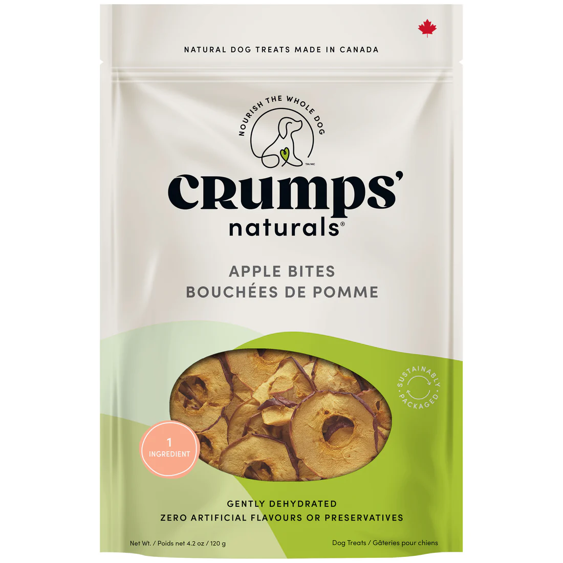 A bag of Crumps’ Naturals Apple Bites dog treats, showing dried apple slices through a window. The package highlights natural ingredients, no artificial flavors or preservatives, and is made in Canada.