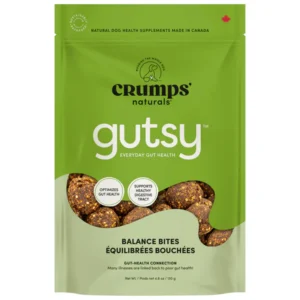 A green resealable bag of Crumps' Naturals Gutsy Balance Bites dog treats, featuring images of the treats and text highlighting gut health benefits. The package is labeled as made in Canada.