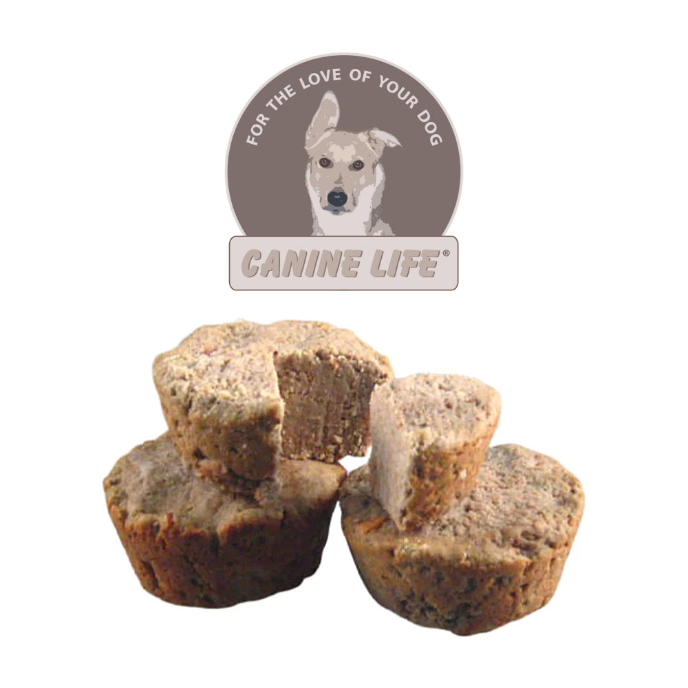 Three muffin-shaped dog treats are stacked in front of a circular Canine Life logo featuring a dog’s face and the words “For the Love of Your Dog.” One treat is cut in half to show the inside texture.