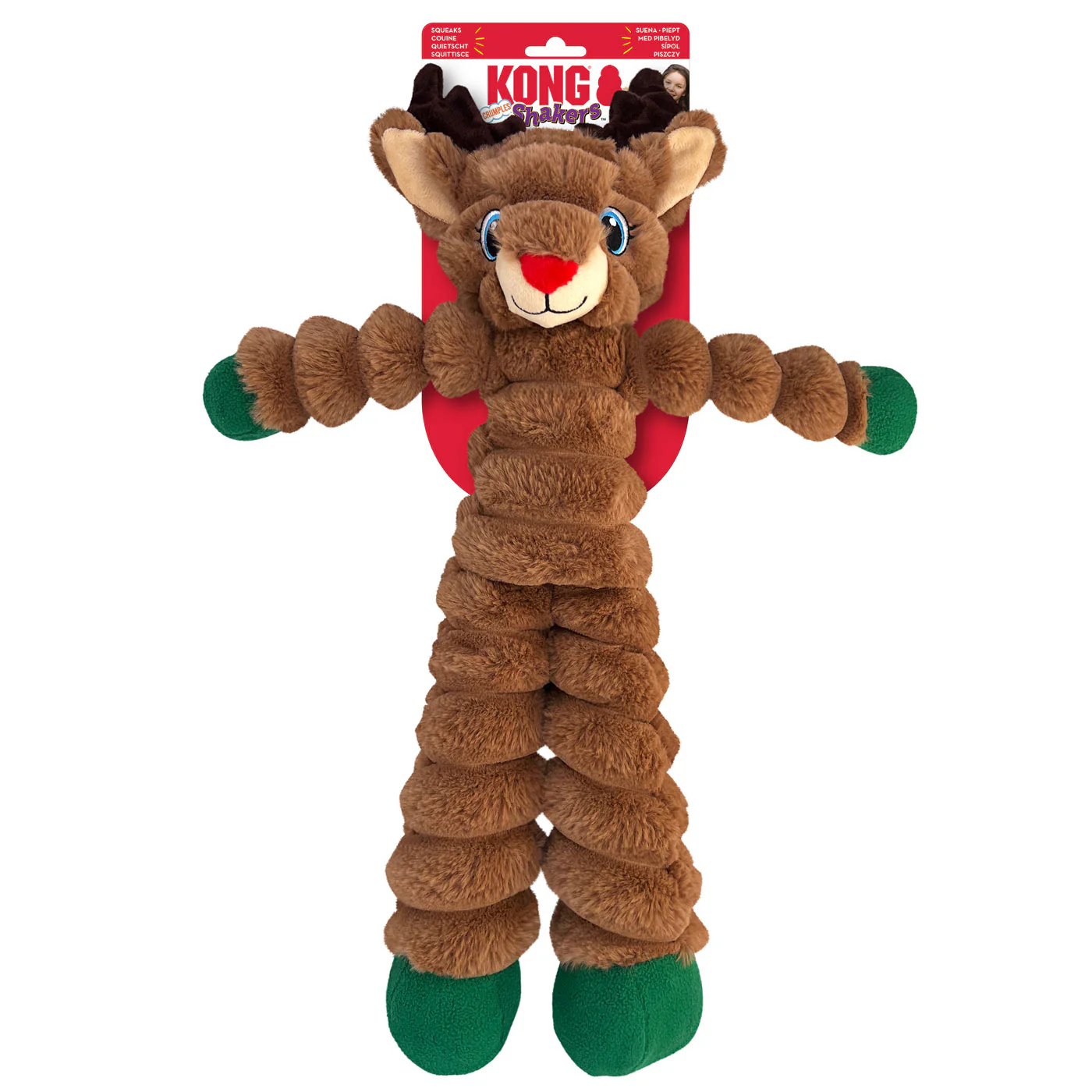 A brown plush reindeer dog toy with corrugated body and green feet. Its face has large eyes and a red nose. A red tag with "Kong" written in white is attached at the top. The toy has a joyful expression.