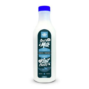 A plastic bottle of Big Country Raw Unpasteurized Goat Milk (975 ml) with a blue cap, featuring a blue and white label that displays “Goat Milk original,” “Lait Chèvre,” and probiotic information.