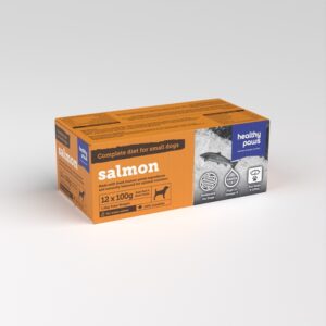 Healthy Paws Salmon Complete 12x100g for small dogs comes in an orange box with 12 packs, featuring salmon images, product info, and icons showing health benefits.