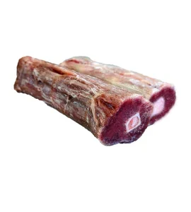 Two pieces of raw, frozen meat with visible bone in the center, shown against a plain white background.