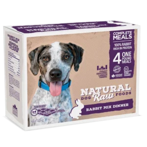 A box of Natural Raw Foods Rabbit Mix Dinner for dogs. The package features a smiling dog, various text highlighting its nutritional benefits, such as 100% rabbit high in protein, and includes meal preparation instructions. The box contains 4 one-pound meals.