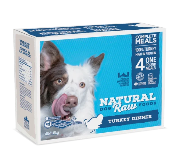 A box of Natural Raw Foods Turkey Dinner for dogs, featuring an image of a dog licking its lips. The box states it contains four 1-pound meals, made with 100% turkey and high in protein. The weight is 4 lbs (1.8 kg).