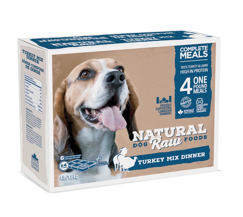 A box of Natural Raw Foods Turkey Mix Dinner for dogs. The packaging features an image of a happy Beagle with its tongue out. Key information includes "Complete Meals," 100% turkey and lamb, 4 one-pound meals, and high in protein. The box weighs 4 lbs (1.81 kg).