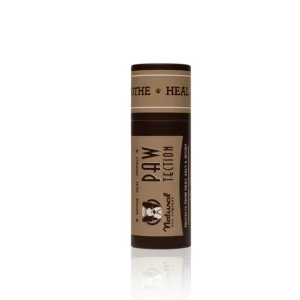 A brown cylindrical container of "PawTection" balm by Natural Dog Company. The product label features the brand logo and texts "Soothe - Heal - Protect". The balm is intended for protecting and healing dog paws.