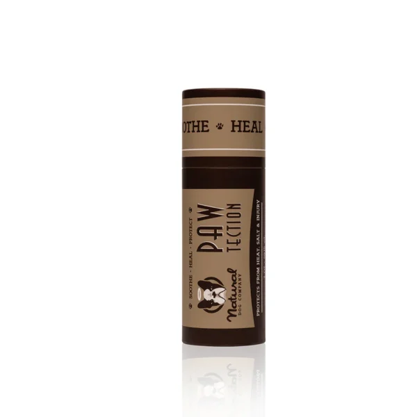 A brown cylindrical container of "PawTection" balm by Natural Dog Company. The product label features the brand logo and texts "Soothe - Heal - Protect". The balm is intended for protecting and healing dog paws.