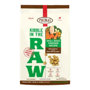 A bag of Primal Pet Foods dog food. The front label reads "Kibble in the Raw," "Small Breed Chicken Recipe," and features chicken kibble pieces. The bag emphasizes natural, raw nutrition suitable for small breed dogs.