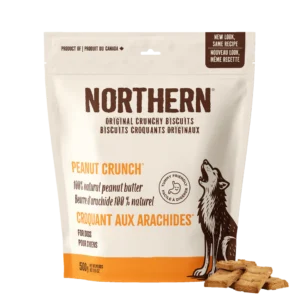 A beige and white 500g bag of Northern Peanut Crunch Biscuit for dogs, featuring an image of a howling wolf and square biscuits, with English and French text.