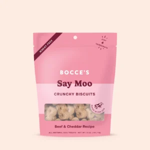 A pink and light pink resealable bag of Bocce’s Say Moo crunchy biscuits for dogs, labeled as wheat-free and made with beef and cheddar. The biscuits are visible through a clear window at the bottom.