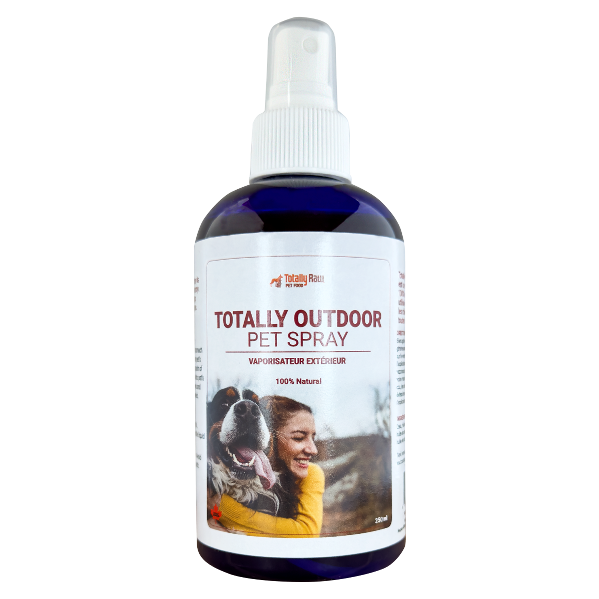 A bottle of Totally Outdoor Pet Spray with a spray nozzle. The label shows a woman hugging a happy dog outdoors and states that the product is 100% natural.