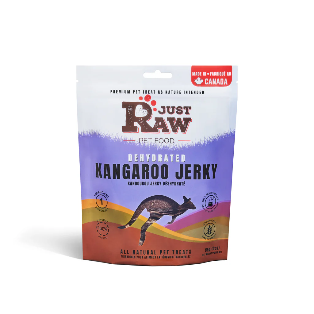 A stand-up pouch of Just Raw Pet Food dehydrated kangaroo jerky treats for pets, featuring a kangaroo silhouette and purple, orange, and white colors. The packaging states it's made in Canada and all natural.