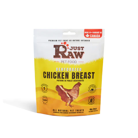 A white and yellow pouch of Just Raw Pet Food Dehydrated Chicken Breast treats, featuring a chicken illustration, product information, and a "Made in Canada" label at the top right.