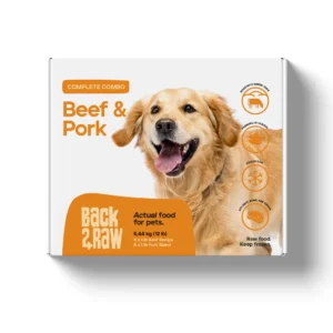 A box of Back2Raw Complete Beef & Pork 12lbs pet food, featuring a happy golden retriever, "Actual food for pets" label, and icons for freshness, raw food, and a paw print on a white background.