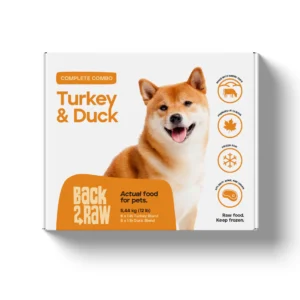 A box of Back2Raw Complete Duck & Turkey 12lbs pet food features a happy Shiba Inu and highlights high protein, grain-free, "Complete Combo," and should be kept frozen.