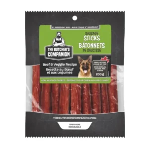 Bag of The Butcher's Companion sausage sticks for dogs. The packaging shows beef and veggie recipe, 200g, with an image of a dog. Labels include "real meat dog treats" and a resealable feature.