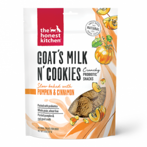 Packaging of "The Honest Kitchen" Goat's Milk N' Cookies dog treats. The front shows orange and white design elements with illustrations of pumpkins. Text highlights "Probiotic Snacks" and "Slow baked with Pumpkin & Cinnamon.