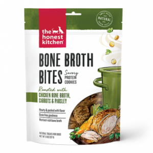 A bag of The Honest Kitchen Bone Broth Bites, savory protein cookies for dogs, featuring chicken bone broth, carrots, and parsley. The packaging shows a stew pot and illustrated ingredients.