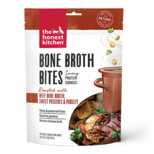 A package of The Honest Kitchen Bone Broth Bites, savory protein cookies for dogs, featuring beef bone broth, sweet potatoes, and parsley. The bag shows images of the treats, ingredients, and a pot of broth.