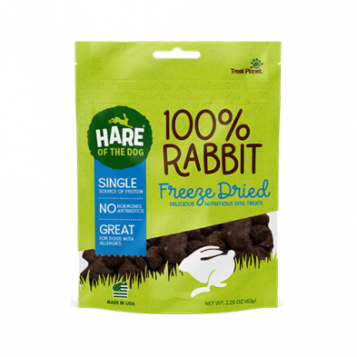 A green and white bag of Hare of the Dog 100% Rabbit Freeze Dried dog treats, featuring a white rabbit silhouette, product benefits, and navy blue accents. The bag contains 2.25 oz (62g) of treats.