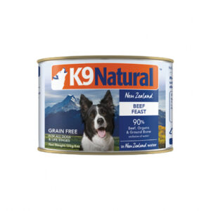 A can of K9 Natural dog food labeled "Beef Feast" featuring an image of a dog and mountains. It is grain-free, with 90% beef, organs, and ground bone, and is suitable for all life stages. Net weight: 170g/6oz.