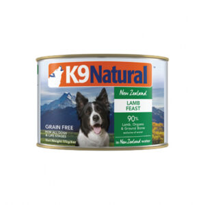 Can of K9 Natural Lamb Feast dog food, featuring a black and white dog with mountains in the background. Text highlights it is grain-free, contains 90% lamb, organs, and ground bone, and is made with New Zealand water. Net weight 170g (6oz).