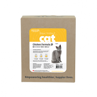 A box of Basic Instinct Cat Chicken Formula raw cat food, featuring a label with a photo of a gray cat and product details. The box reads “Empowering healthier, happier lives.” at the bottom.