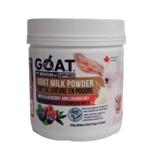 A container of G.O.A.T. goat milk powder for pets, featuring an image of a goat and blueberries and cranberries. The label states it's made in Canada and contains probiotics and digestive enzymes.