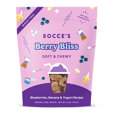 A purple and pink bag of Bocce's Berry Bliss Soft & Chewy dog treats, featuring images of blueberries, bananas, and yogurt, with a clear window displaying the treats inside. The bag notes it's wheat-free.