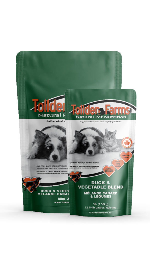 Two green and orange bags of Tollden Farms Duck & Vegetable 8 lbs pet food, featuring images of a dog, cat, and rabbit on the packaging, highlighting natural pet nutrition.