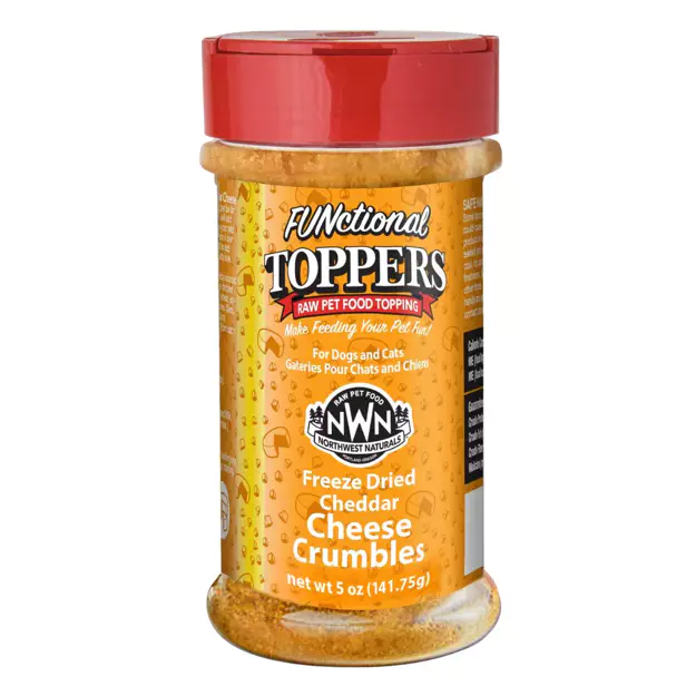 A clear plastic jar with a red lid containing NWN Functional Toppers Freeze Dried Cheddar Cheese Crumbles, a raw pet food topping for dogs and cats. The label is orange with white and yellow text. Net weight is 5 oz.