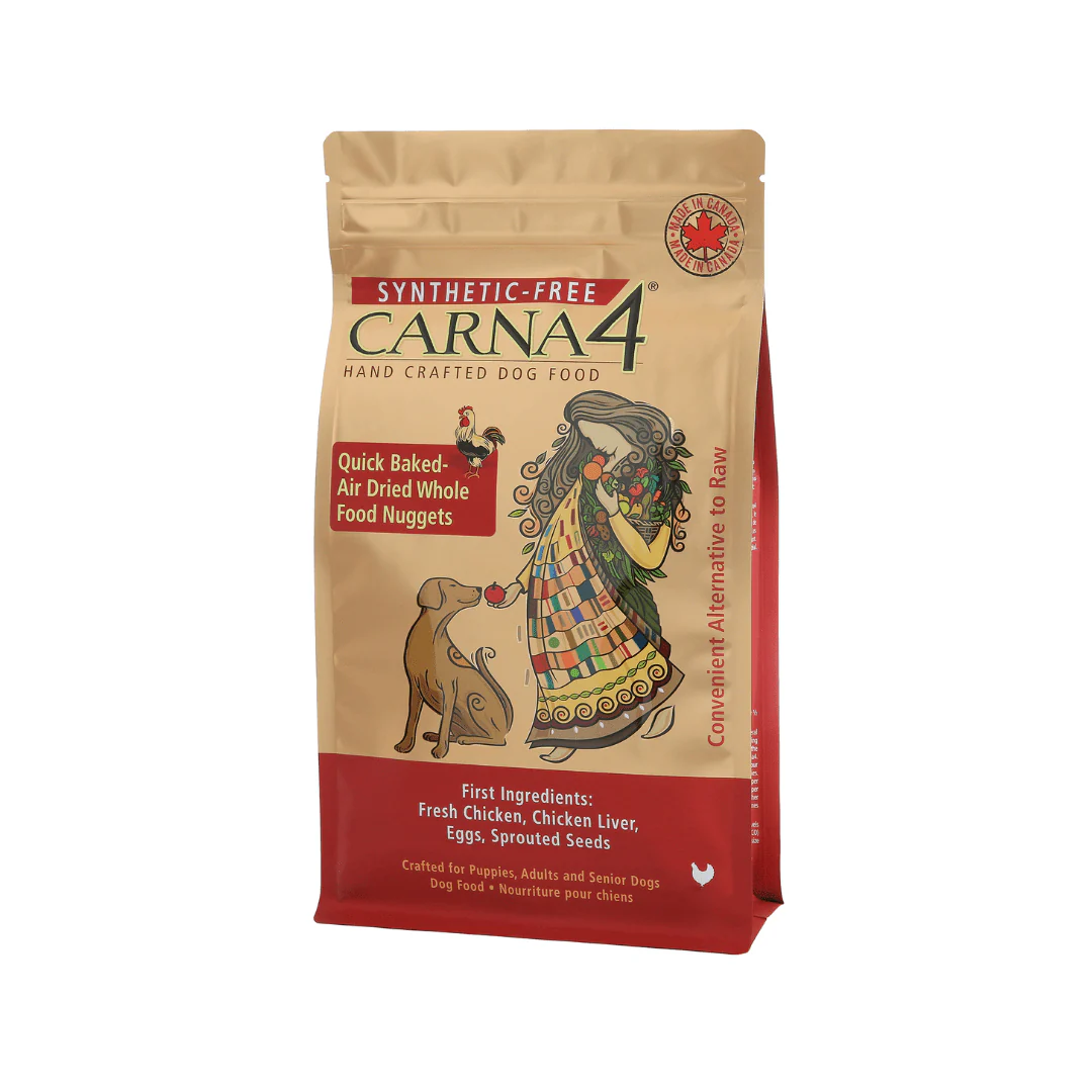 Dog food bag labeled "Carna4" featuring a colorful illustration of a woman and dog. Text highlights "Quick Baked-Air Dried Whole Food Nuggets" with first ingredients: fresh chicken, chicken liver, eggs, and sprouted seeds.