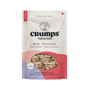 A bag of Crumps' Naturals Mini Trainers dog treats, pork hearts flavor. The packaging is white and pink with images of the treats, and text stating "freeze dried, 1 ingredient, no artificial flavors.