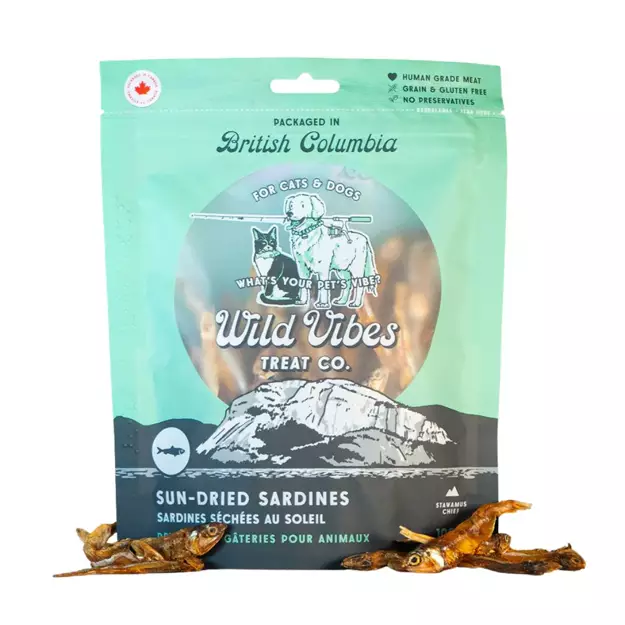 A package of Wild Vibes Treat Co. Sun-Dried Sardines for cats and dogs, labeled as human grade, grain and gluten free, with dried sardines displayed in front of the blue and green packaging.
